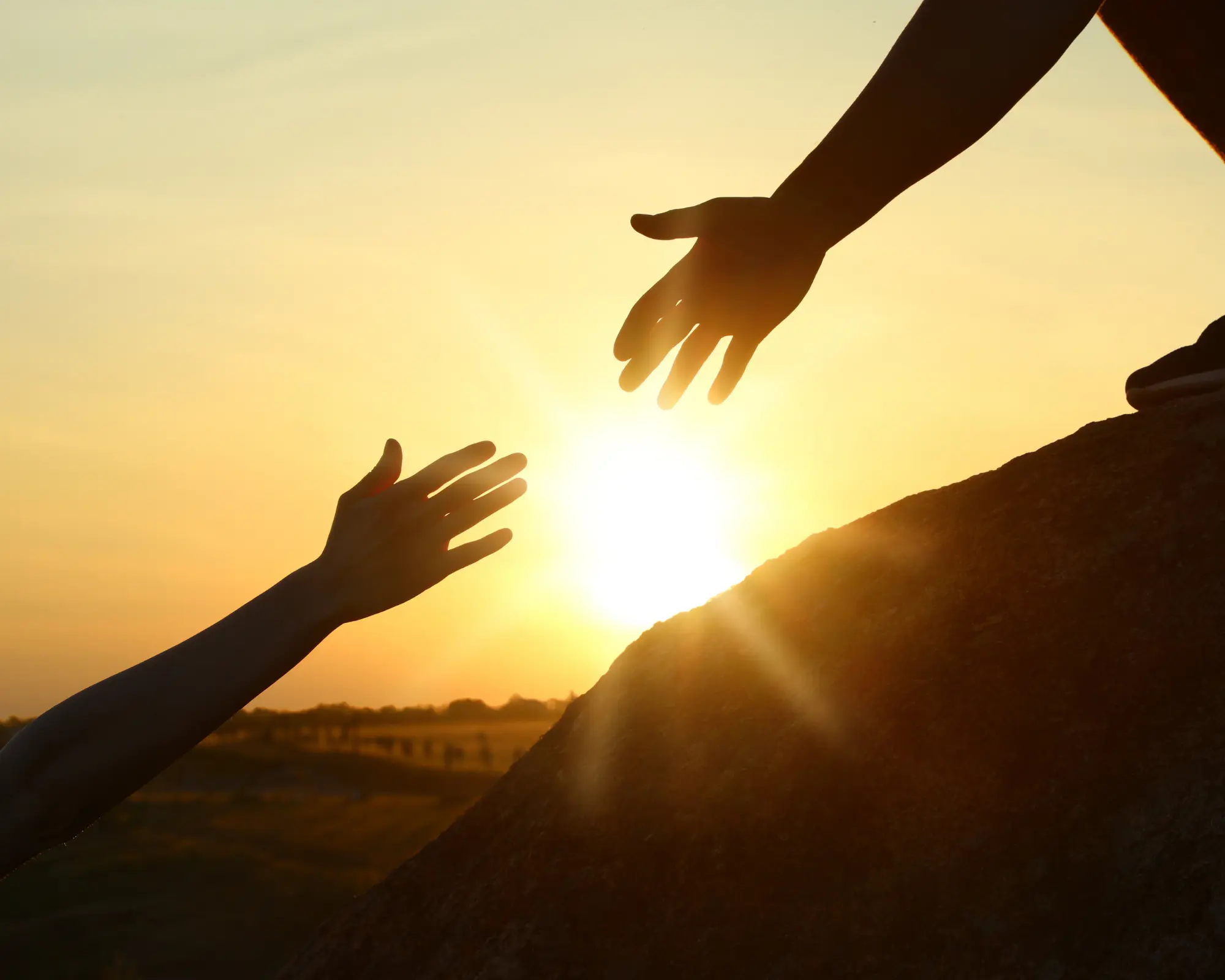 Hiker Helping Friend Outdoors at Sunset. Help and Support Concept